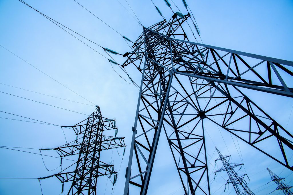 Electricity pylons on blue sky background. Power and energy. Energy conservation